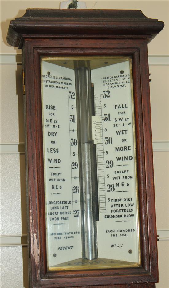 A late Victorian Negretti and Zambra oak stick barometer, 3ft 4in.